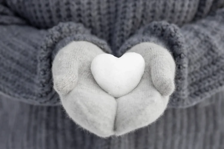 close-up-hands-holding-snow-heart (1)